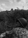 PVT. ROBIN MARKEY LOOKING UP THE HILL AT LT. TOM BOWERS